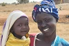 Avec son bébé, l’esclave libérée Abuk Angok Chamiir vit de nouveau dans son pays natal, le Soudan du Sud. csi